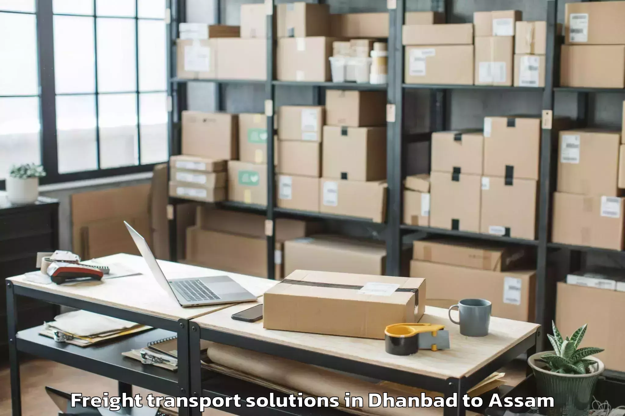 Trusted Dhanbad to Basugaon Freight Transport Solutions